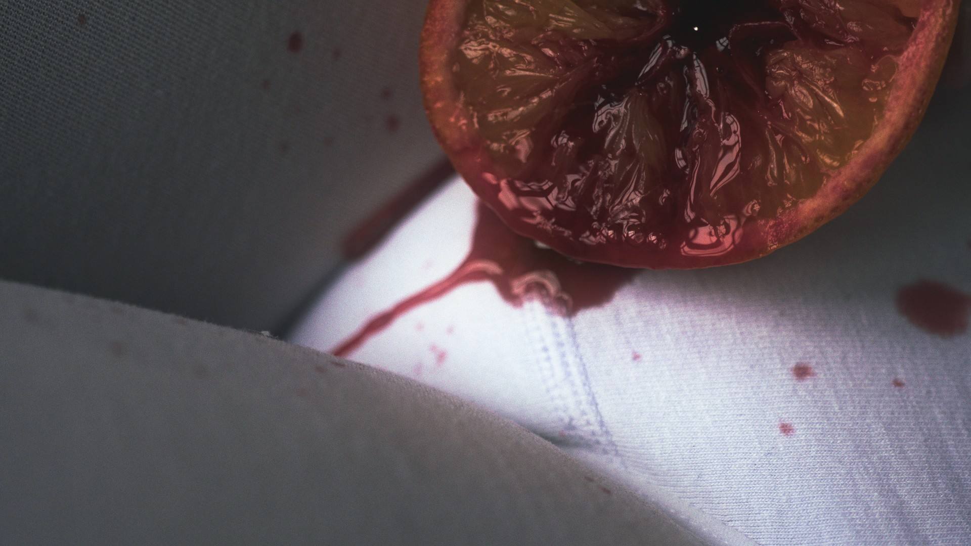The same blood orange, juice running down the sheet